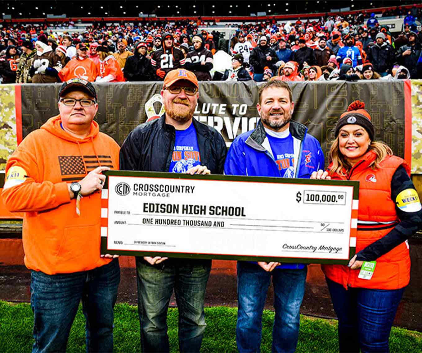CBO Laura Soave presenting the $100,000 donation to Kip Soviak and Edison High Schools' Football Coaches