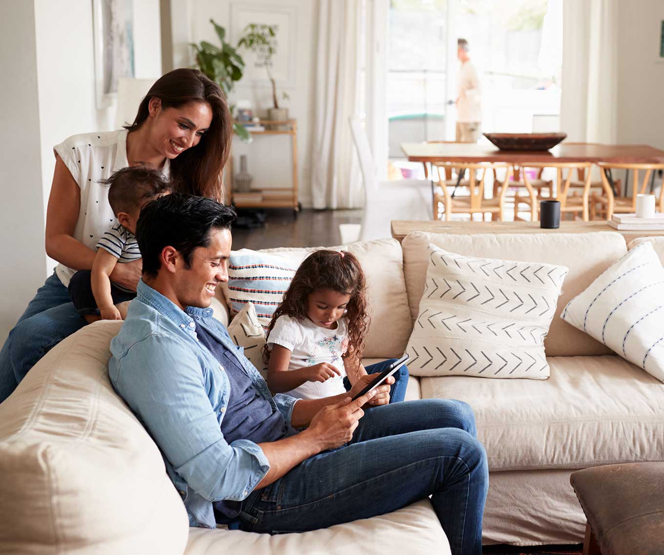 A man and a woman with their kids in their new house
