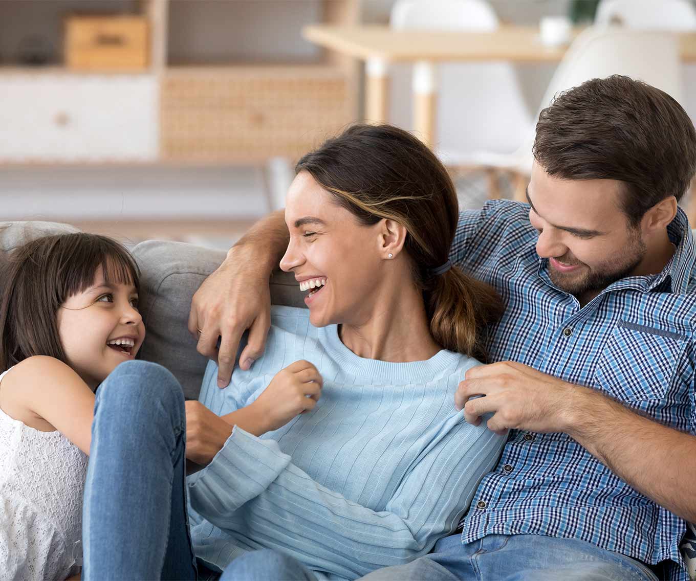 A family laughing and not worrying thanks to the equity they found in their home.