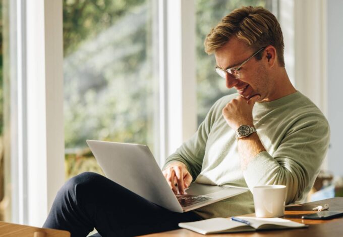 A renter researching on his laptop how he can buy his first home and become a homeowner.