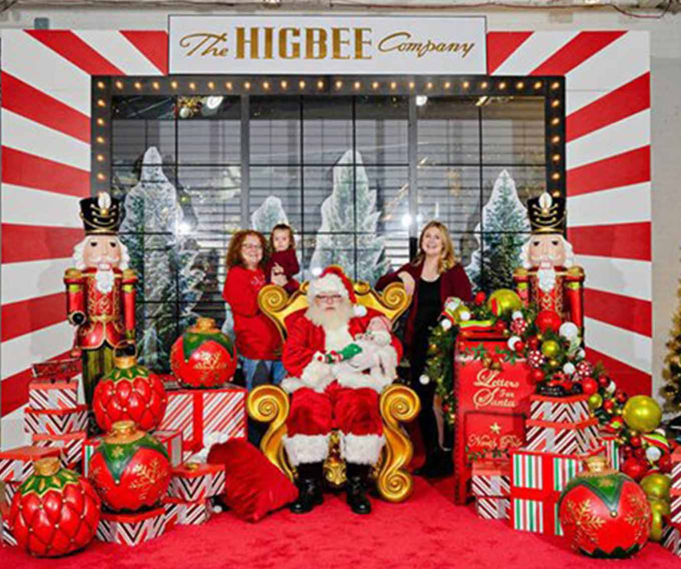 A family posing with Santa Claus at CrossCountry Mortgage headquarters.