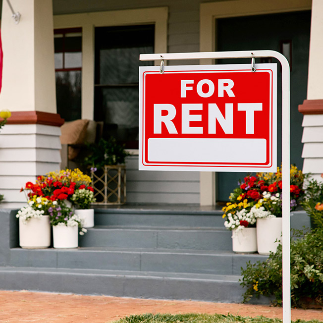 For sale sign showed outside of a duplex investment property available for purchase using DSCR loans.