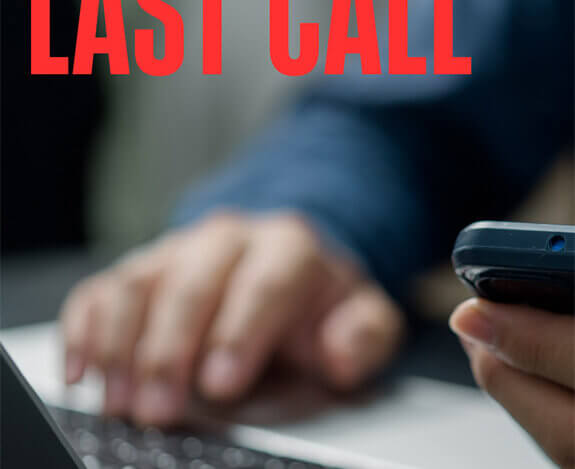 Close up of someone holding a cell phone at a desk with a laptop. Text in the top left corner reading this is the last call.