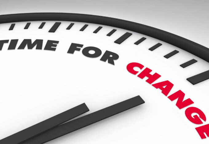 A clock face with "time for change" written on it.