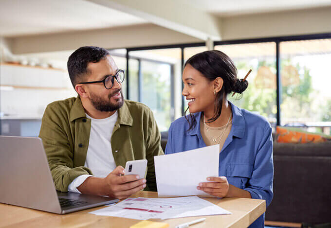 man and woman sitting at table and discussing expenses.