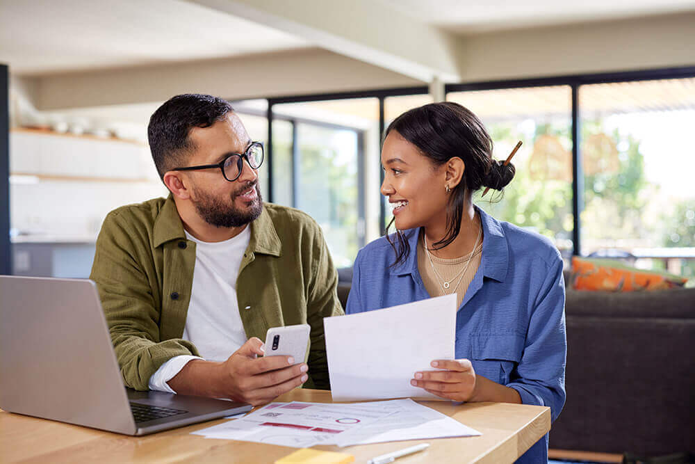 man and woman sitting at table and discussing expenses.