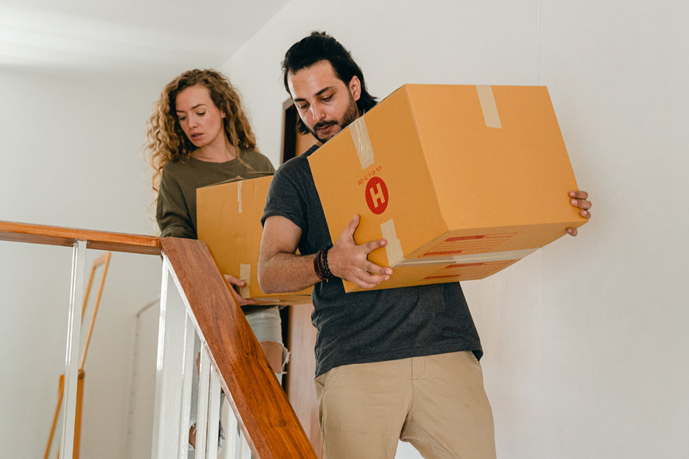 New homeowners moving boxes into their new home.