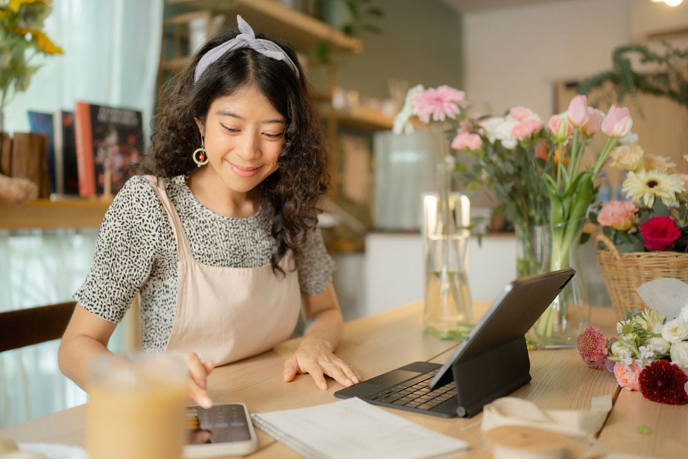 A woman sitting at a table researching non-qm loans