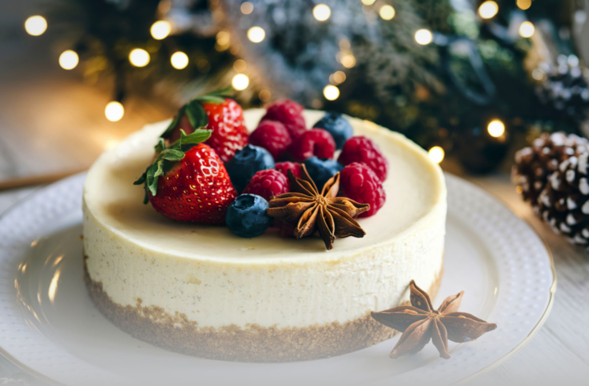 A cake on a plate. Topped with berries.