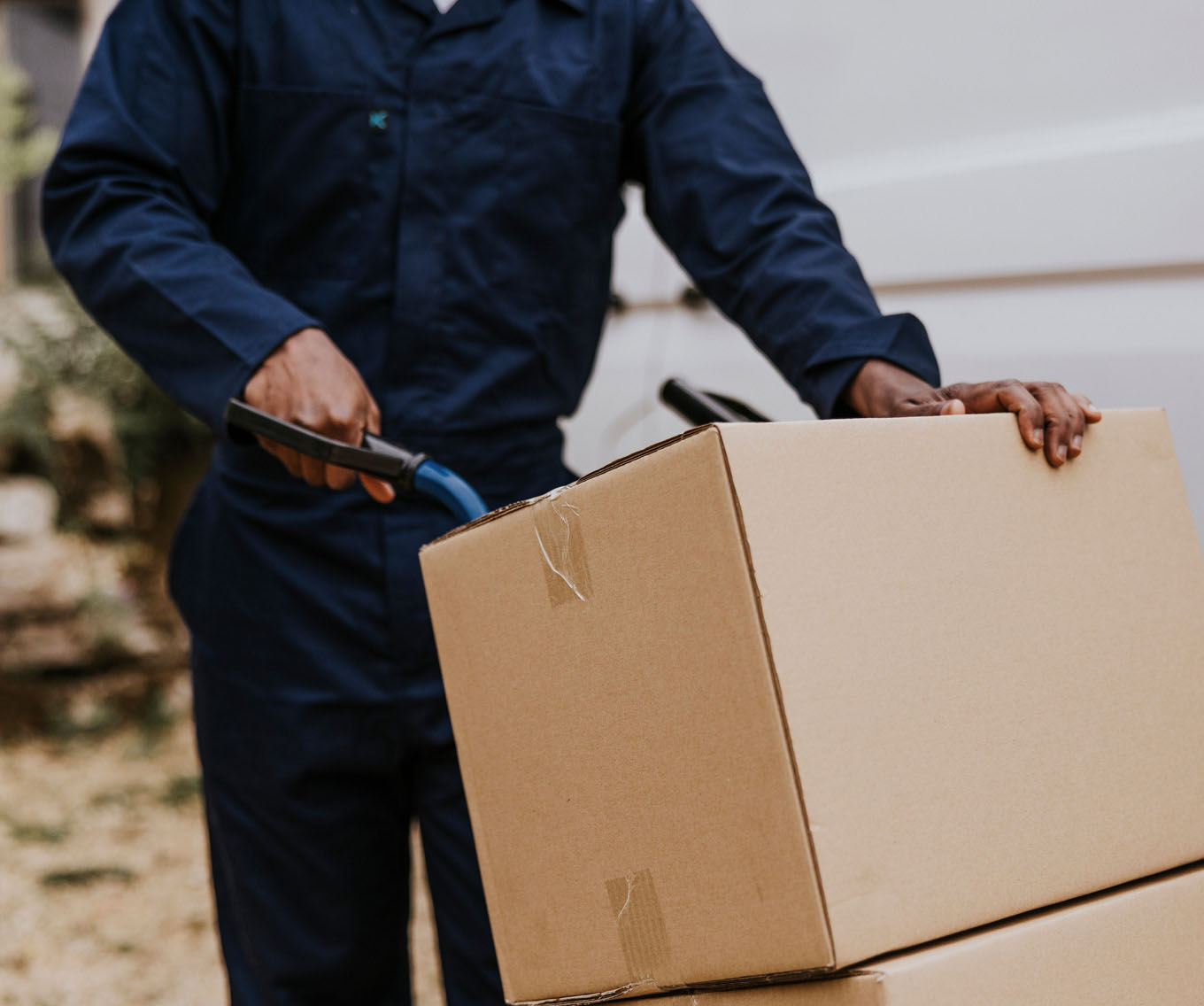 Movers from a moving company carry boxes into a newly purchased home.