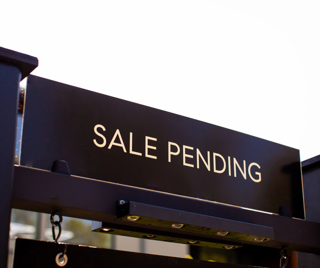 Pending real estate sign in front of a home indicating the seller has accepted an offer and the property is under contract.