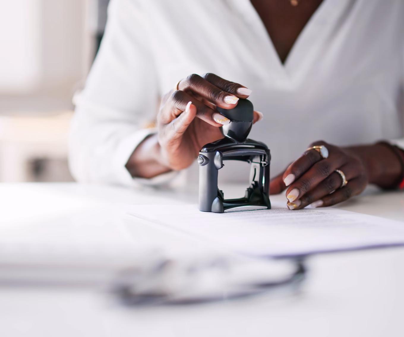 Woman reviewing loan details and writing notes about annual percentage rate (APR) at her desk.