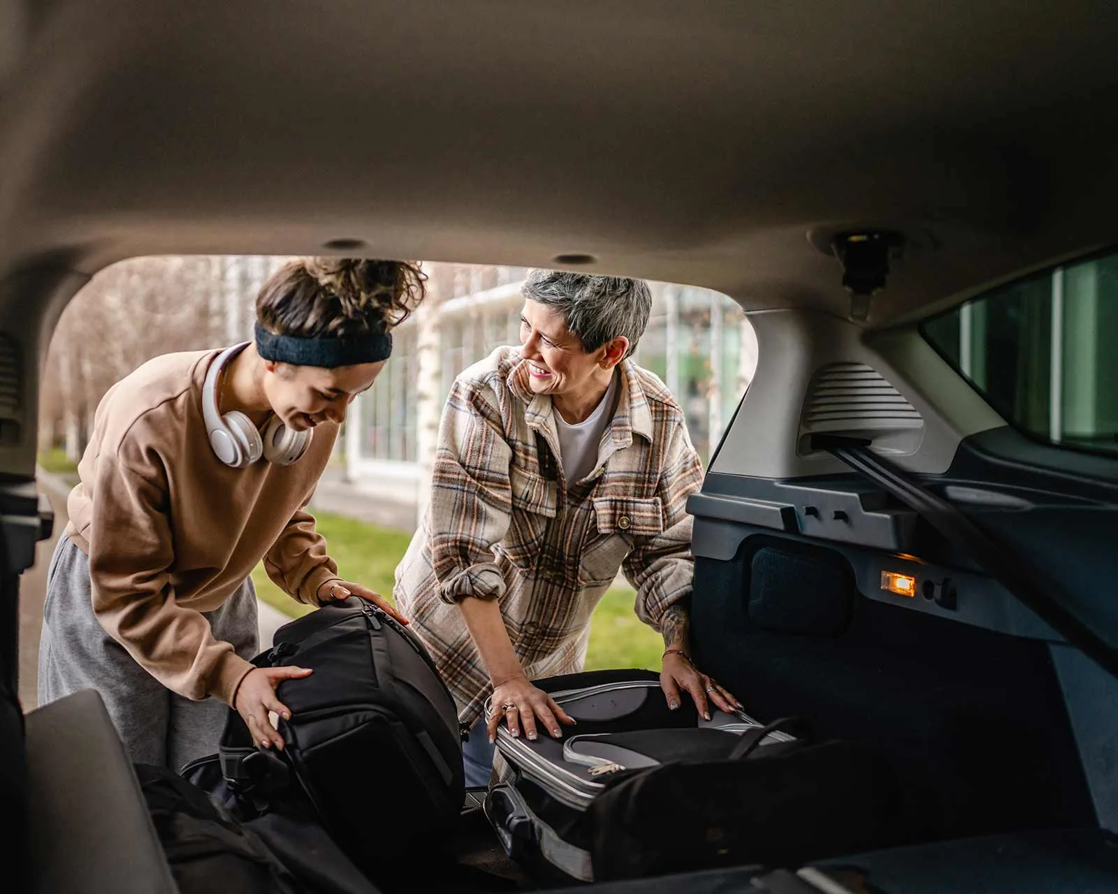 Mother and daughter pack their car for a move to college financed using an fha cash-out refinance.