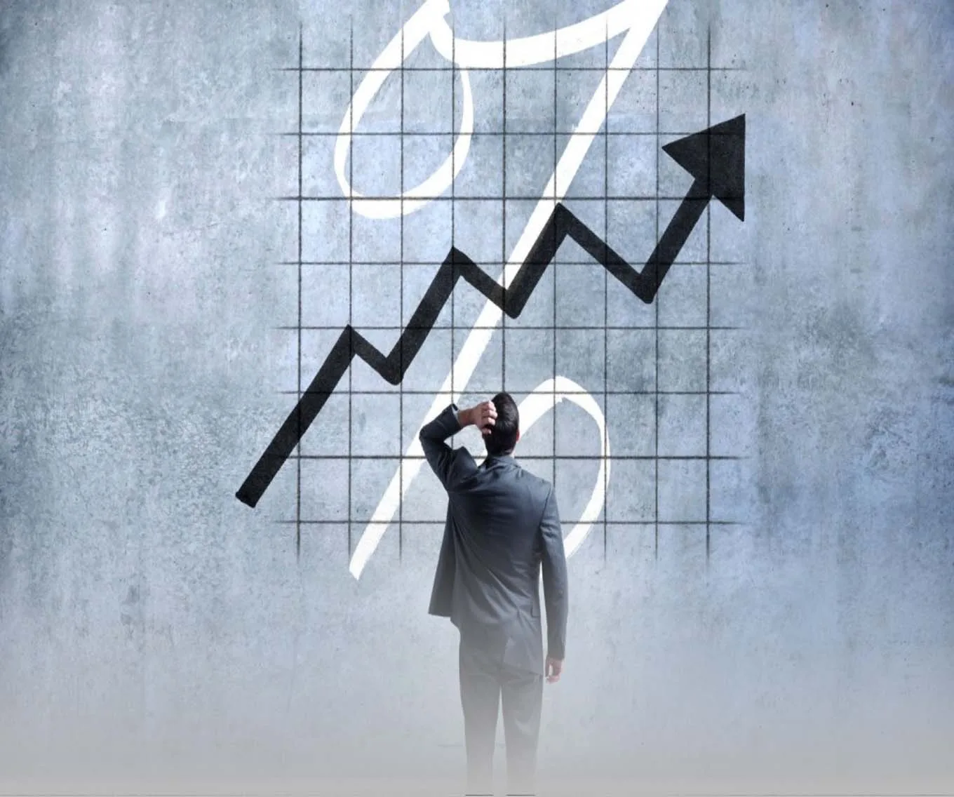 A man in a suit scratching his head. Looking at a large graph on a wall.