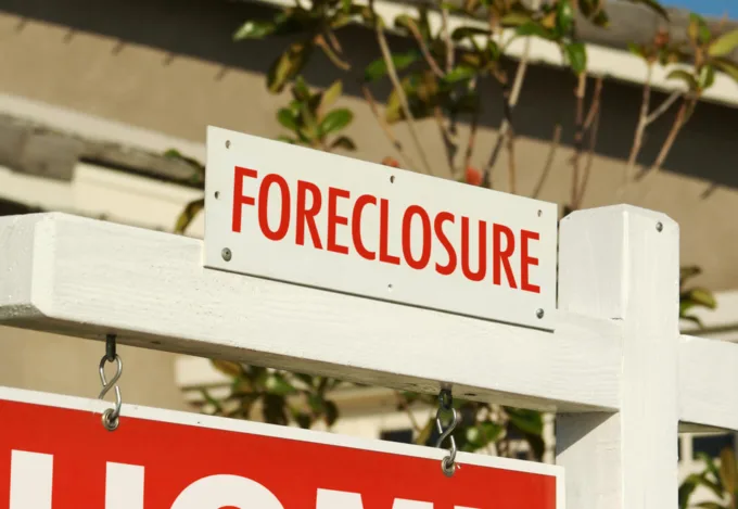 Foreclosure sign posted in front of a home.