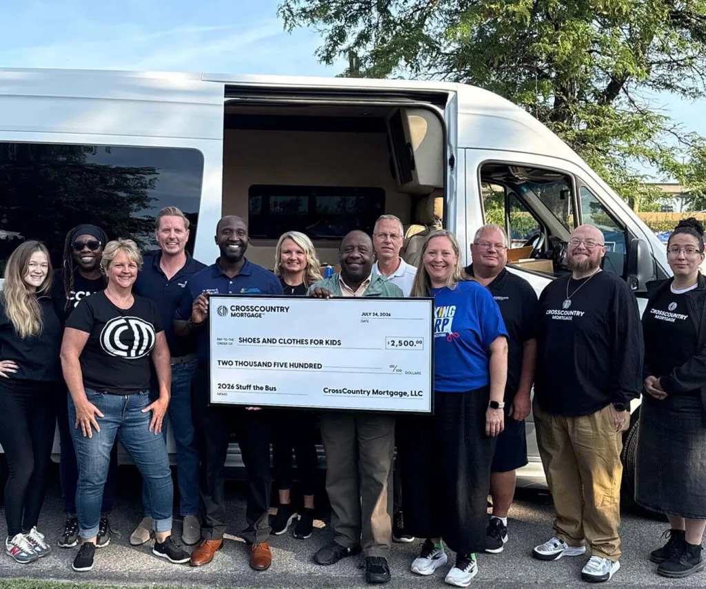 CrossCountry Mortgage presents a $2,500 donation to Shoes and Clothes for Kids during the 2026 Stuff the Bus drive.