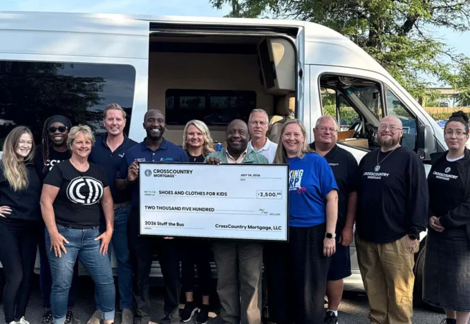 CrossCountry Mortgage presents a $2,500 donation to Shoes and Clothes for Kids during the 2026 Stuff the Bus drive.