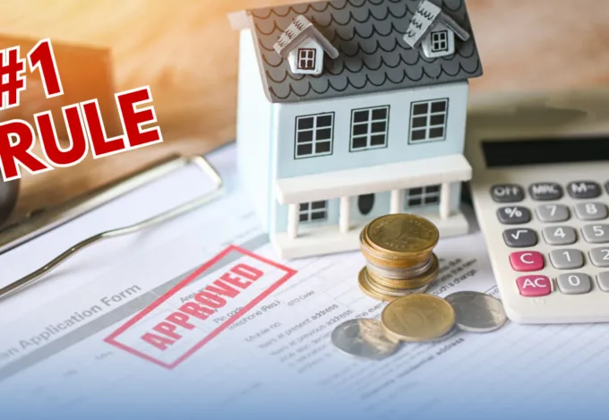 #1 Rule: approved loan application form with a miniature house model, stacked coins, and a calculator