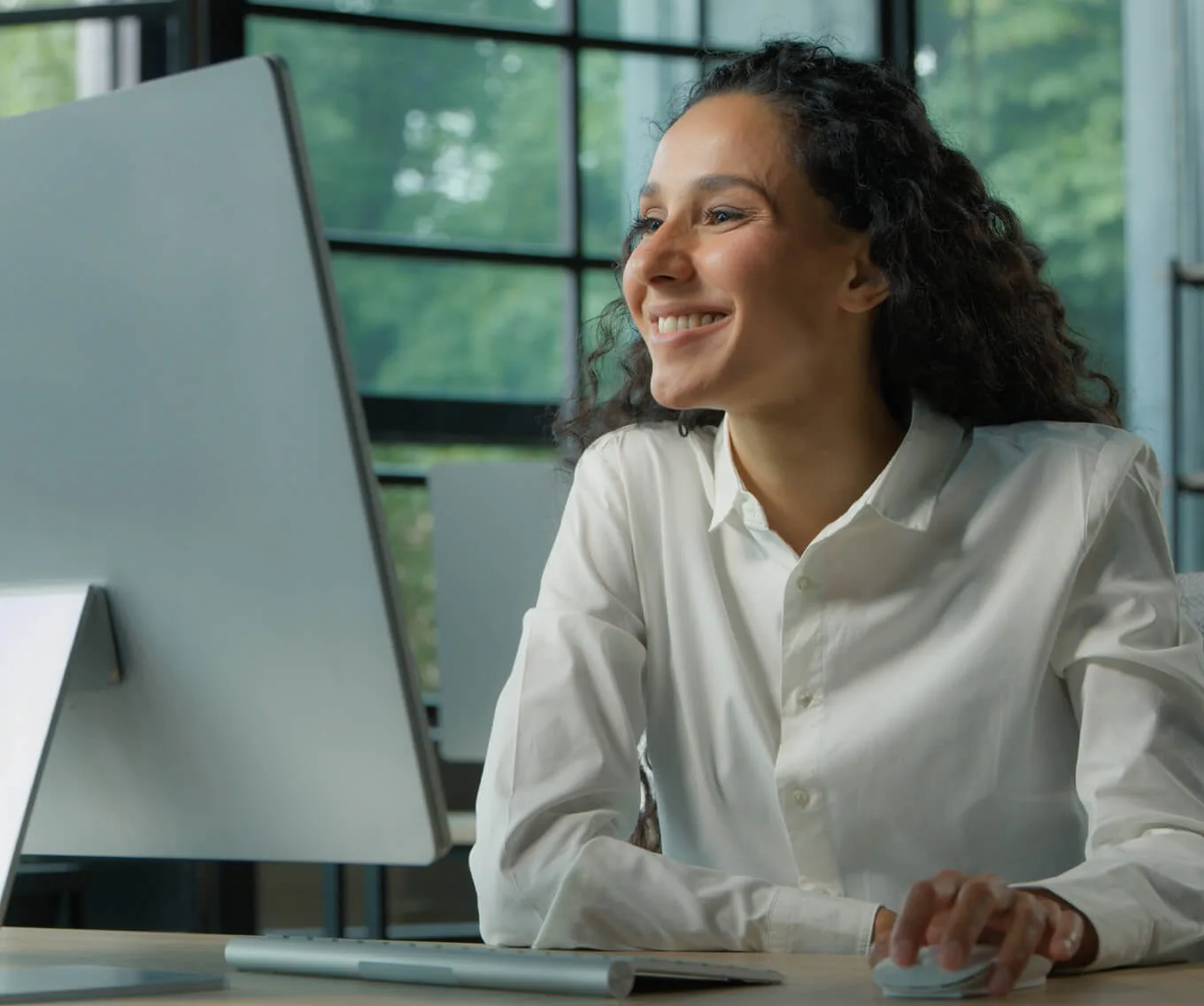 Woman using a computer to research who owns a property online.