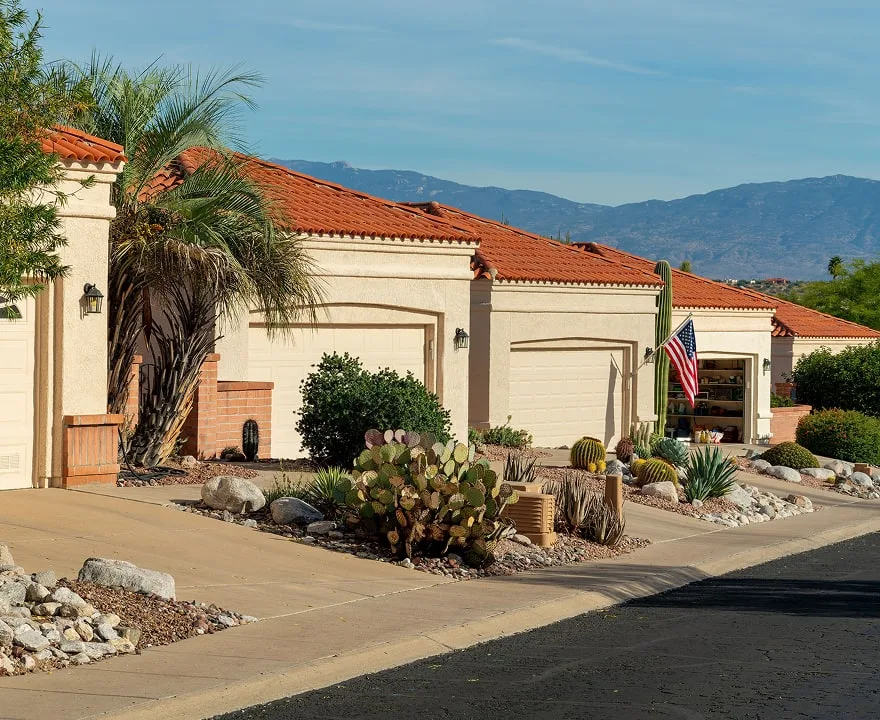 Southwestern-style homes in Arizona with stucco exteriors, red tile roofs, desert landscaping, cacti and mountain views in the background.