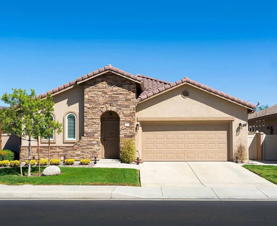 Stucco and stone single-family home in California with a tile roof and attached two-car garage.