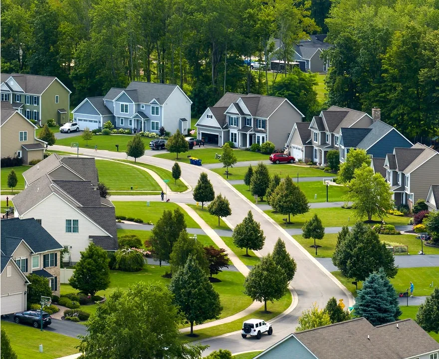 Aerial view of a suburban neighborhood with single-family homes representing residential housing and homeownership in New York.