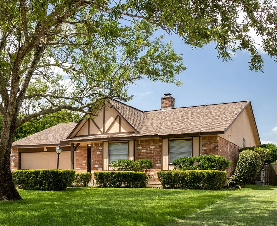 Brick single-family home in Ohio with a large front lawn and mature trees.