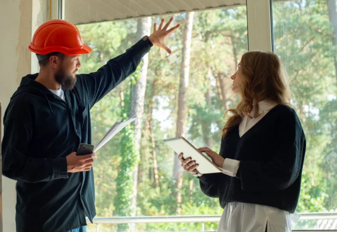 Home inspector discussing repair findings with a prospective homebuyer during a home inspection.