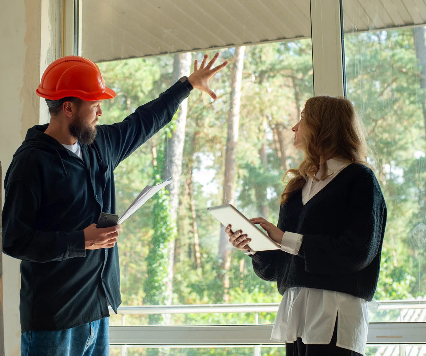 Home inspector discussing repair findings with a prospective homebuyer during a home inspection.