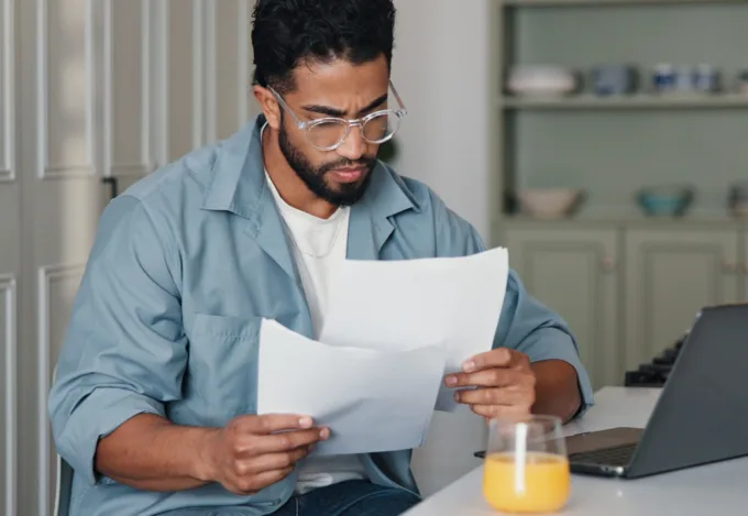 Homeowner reviewing financial documents to understand a lien on a house.